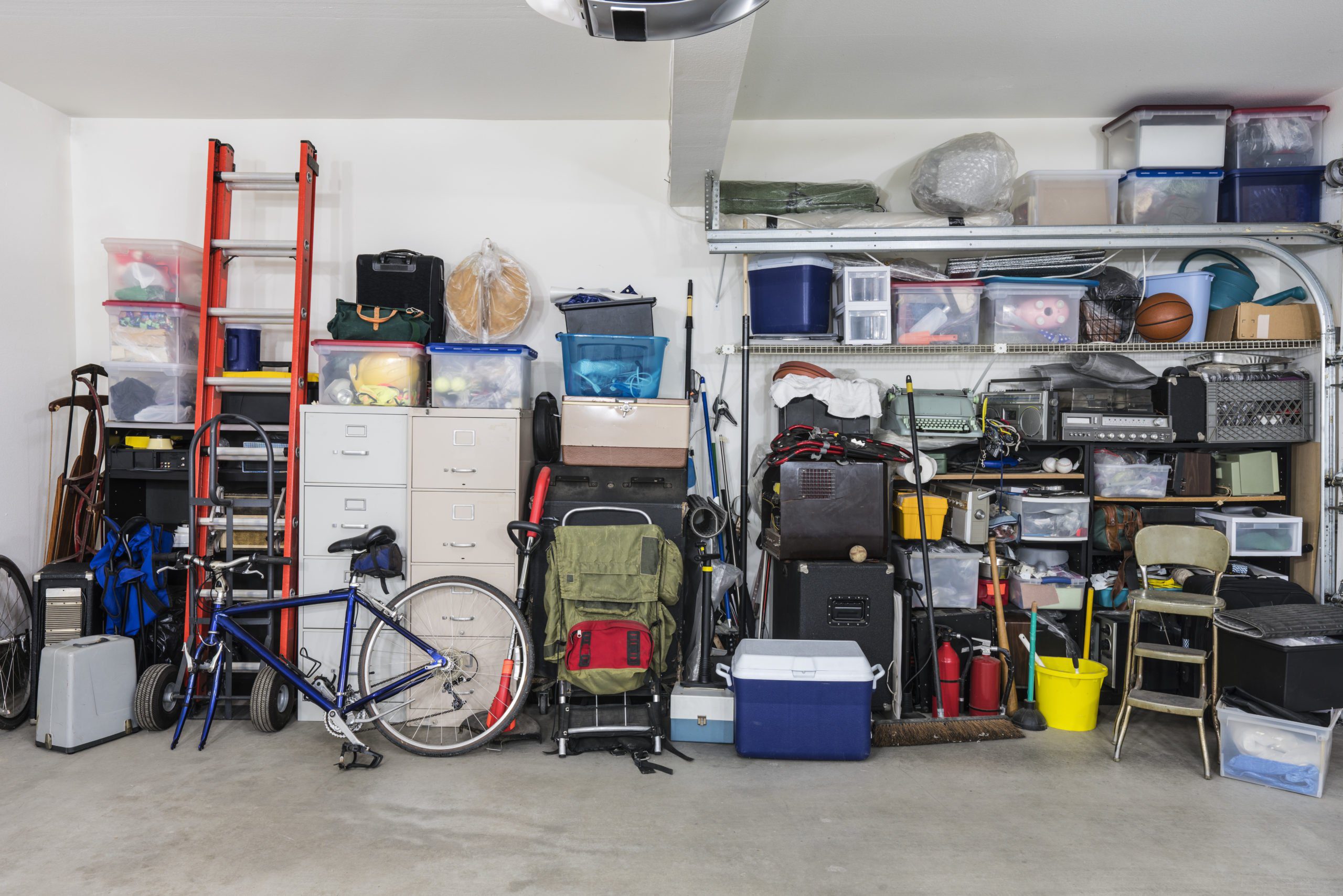 Garage storage shelves with vintage objects and equipment.